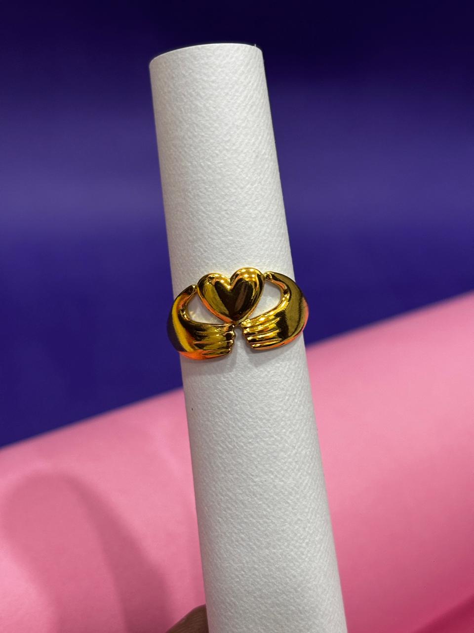 Sue Conway Clasping Hands with Heart Rings